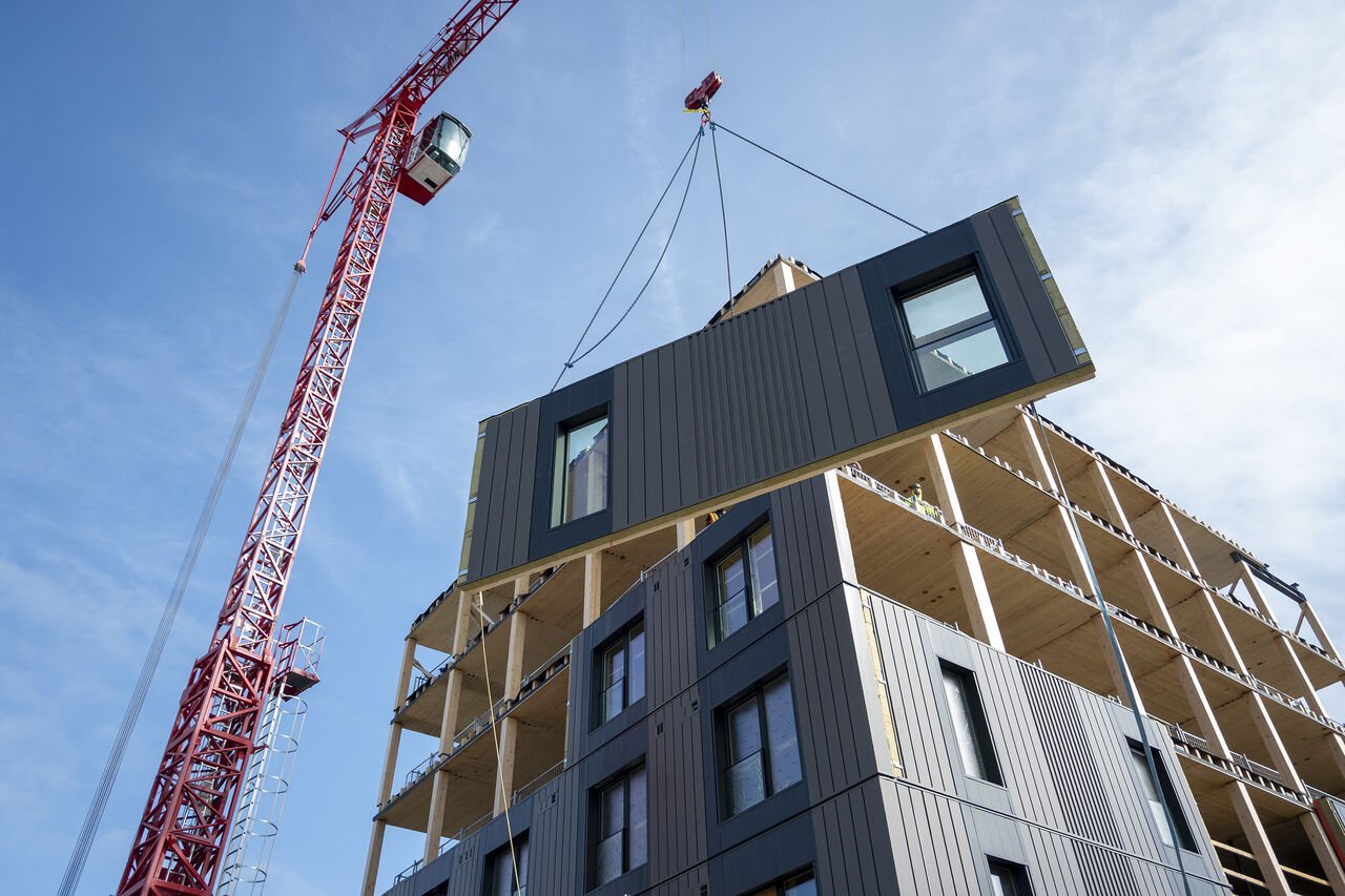 Facade panel swinging into place against the sky