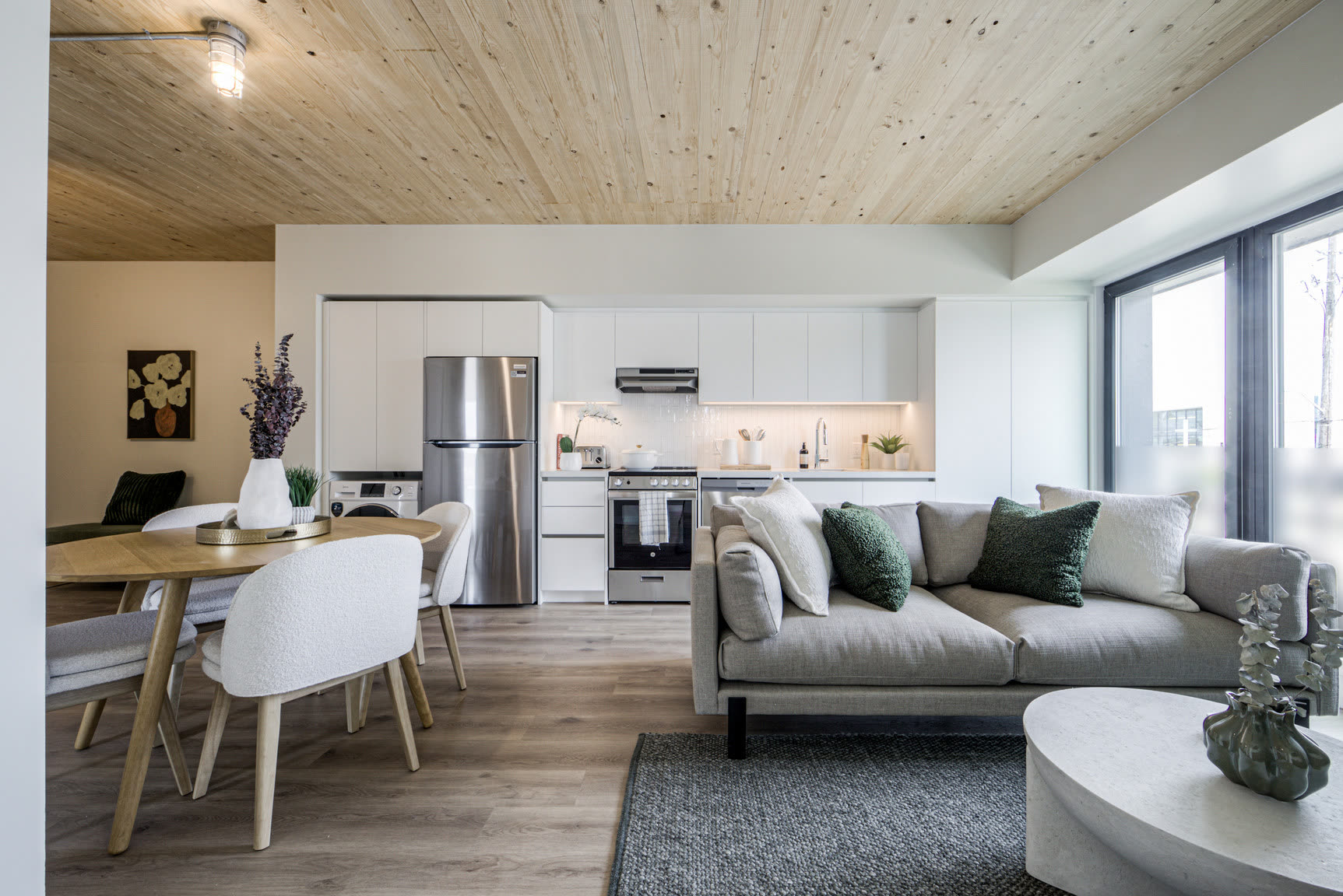 hälsa suite living and kitchen under an exposed mass-timber ceiling